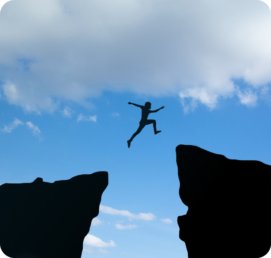 Person leaping between cliffs, representing the pricing challenge